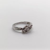 A 9ct white gold and graduated diamond trilogy ring, in a twist mount, diamonds 0.20ct, ring size