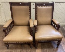 A pair of early 20th century oak framed armchairs
