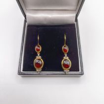 A pair of silver and 9ct yellow gold, cabochon garnet and diamond double drop earrings, with hook