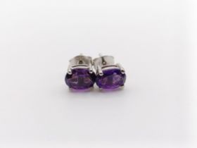 A pair of amethyst studs, in silver