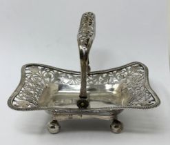 A pierced silver swing handled basket, marks rubbed, 4.4 ozt