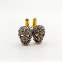 A pair of gold-plated and silver skull cufflinks, set with rose cut diamonds, diamonds 1.80ct