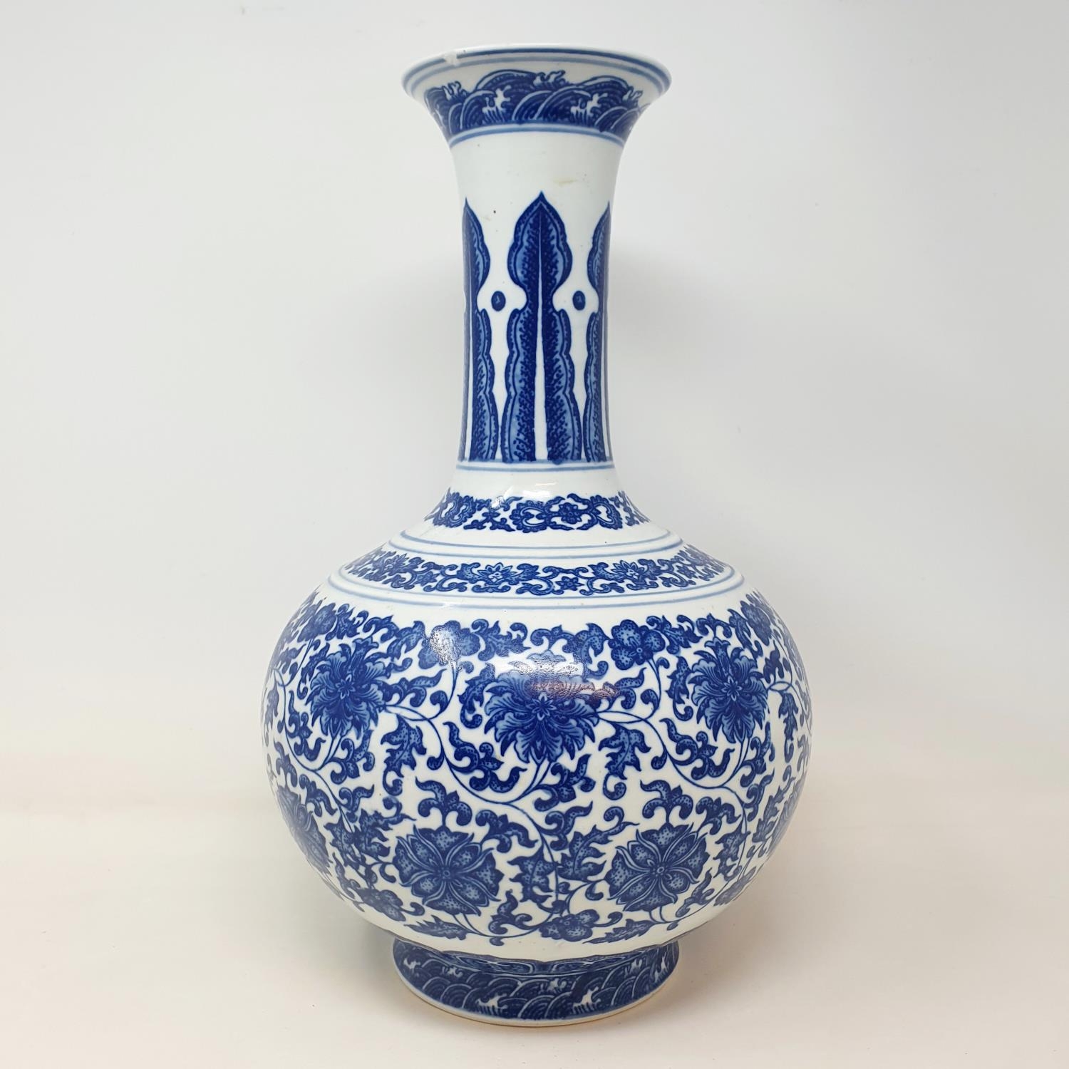 A Chinese blue and white bottle vase, decorated flowers in underglaze blue, bears a Qianlong mark, - Image 6 of 13