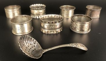 Assorted napkin rings and a sifter spoon, various dates and marks, 5.9 ozt (8)