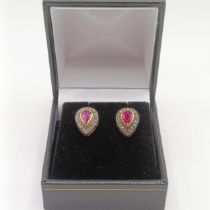 A pair of pear shaped ruby and R/C diamond halo studs, set in gold plated silver, boxed, rubies 0.