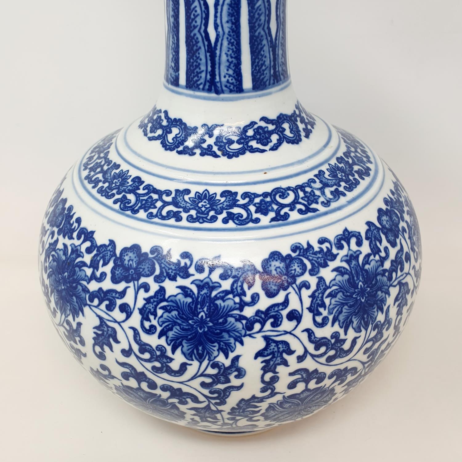 A Chinese blue and white bottle vase, decorated flowers in underglaze blue, bears a Qianlong mark, - Image 4 of 13