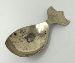 A Continental silver coloured metal novelty caddy spoon, in the form of a whale, marks rubbed, 8.7 g