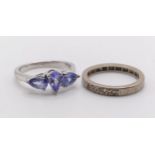 A white stone eternity ring (size J 1/2), and a dress ring, set with purple stones (size L) (2)