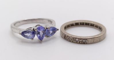 A white stone eternity ring (size J 1/2), and a dress ring, set with purple stones (size L) (2)