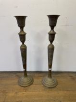 A large pair of Islamic brass candlesticks, 86 cm high