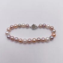 A bracelet, strung with pink, grey, peach and white cultured pearls, with a white metal flower-