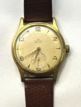 A gentleman's Smiths Deluxe wristwatch, on an associated leather strap