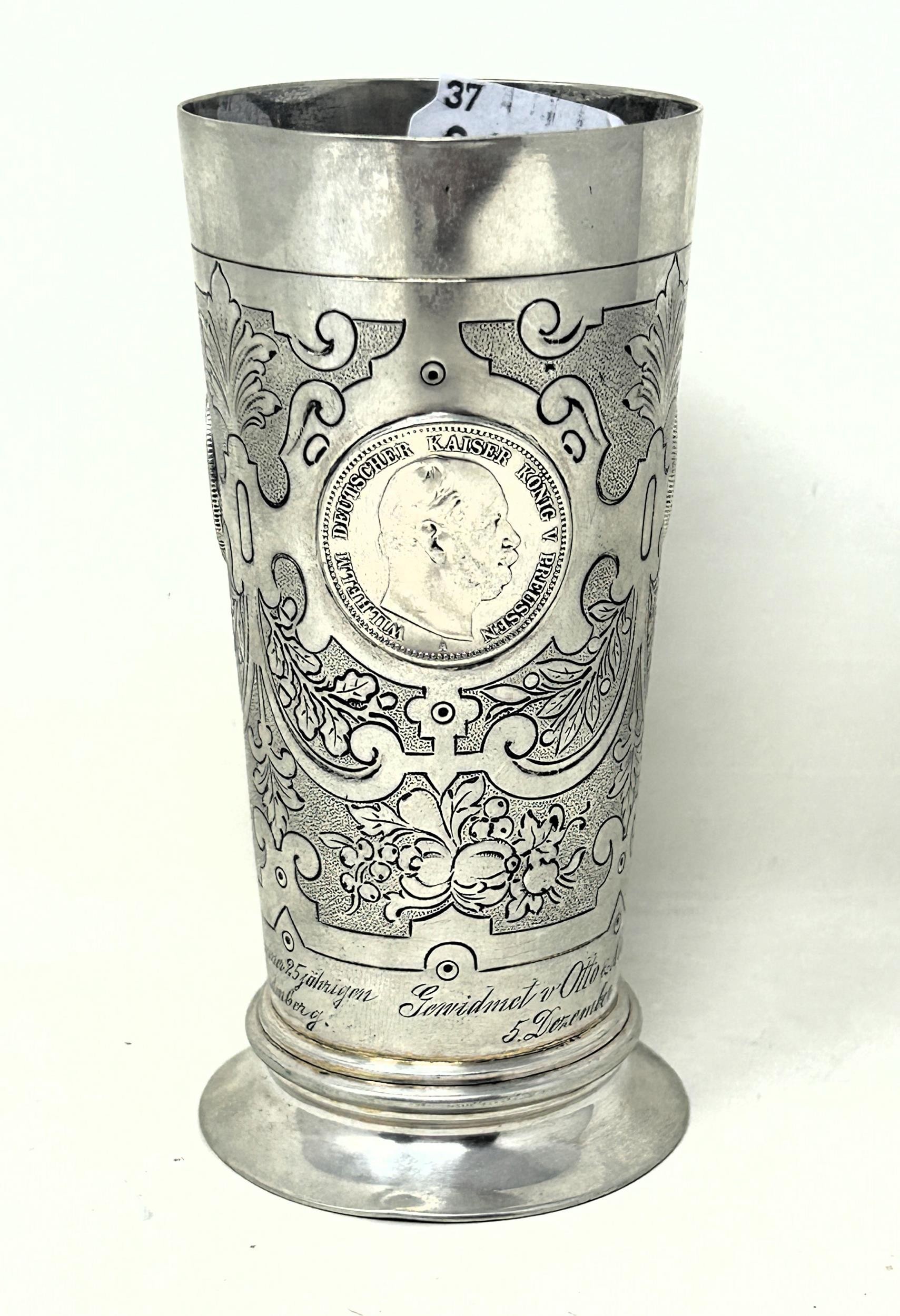 A Continental silver coloured metal beaker, inset with coins, .800 6.4 ozt