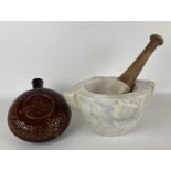 A stoneware hot water bottle, 18 cm diameter, and a pestle and mortar (3)