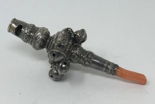 A silver and coral baby's rattle, marks rubbed