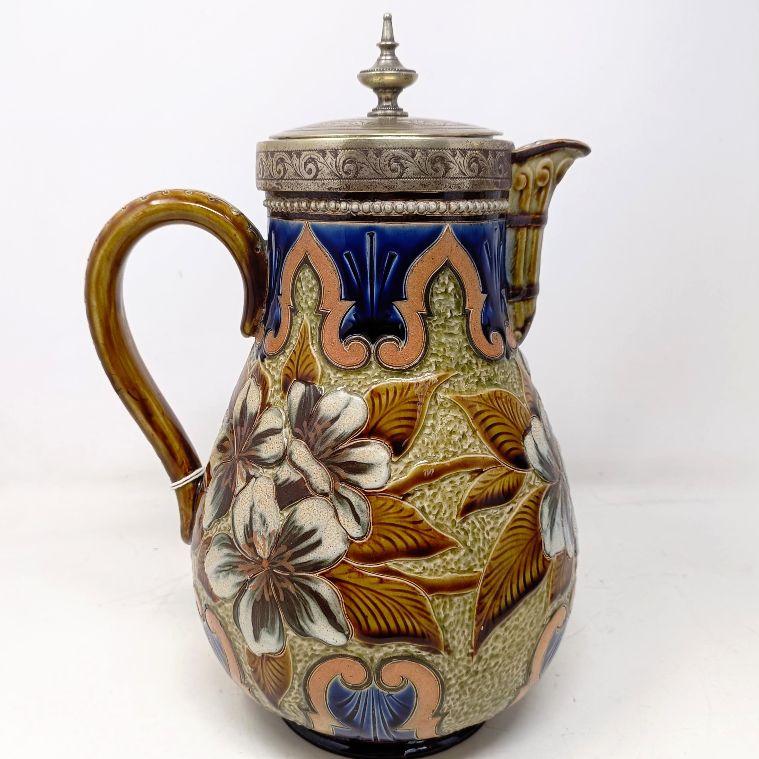 A Doulton Lambeth jug, by Elizabeth M Small, decorated flowers, with a silver plated mount and