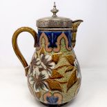 A Doulton Lambeth jug, by Elizabeth M Small, decorated flowers, with a silver plated mount and