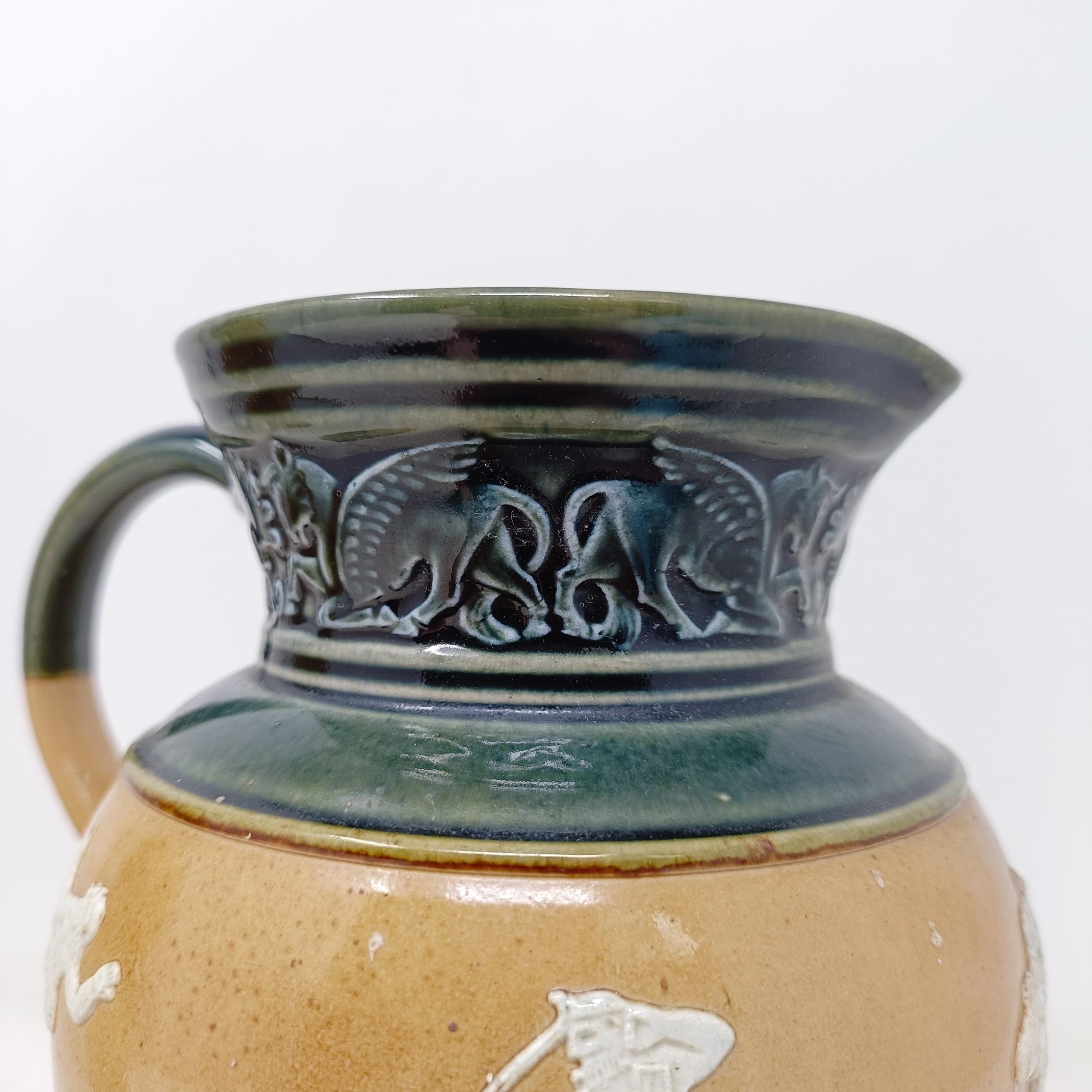 A Doulton Lambeth jug, decorated in Egyptian manner, 20 cm A few rough areas to the touch to the - Image 6 of 8