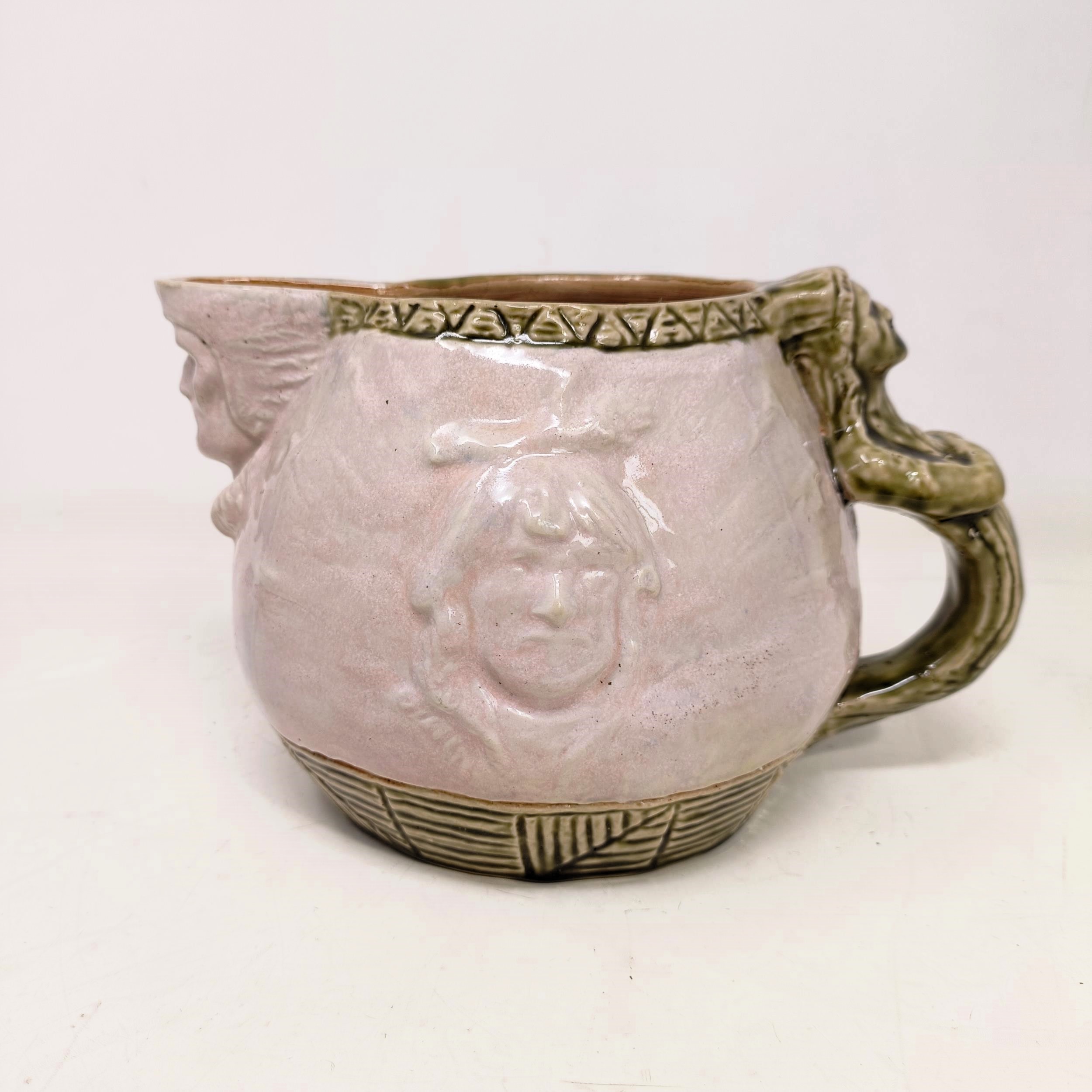 A Doulton Lambeth jug, by Edward Kemeys, decorated with native American Indians, 13 cm high