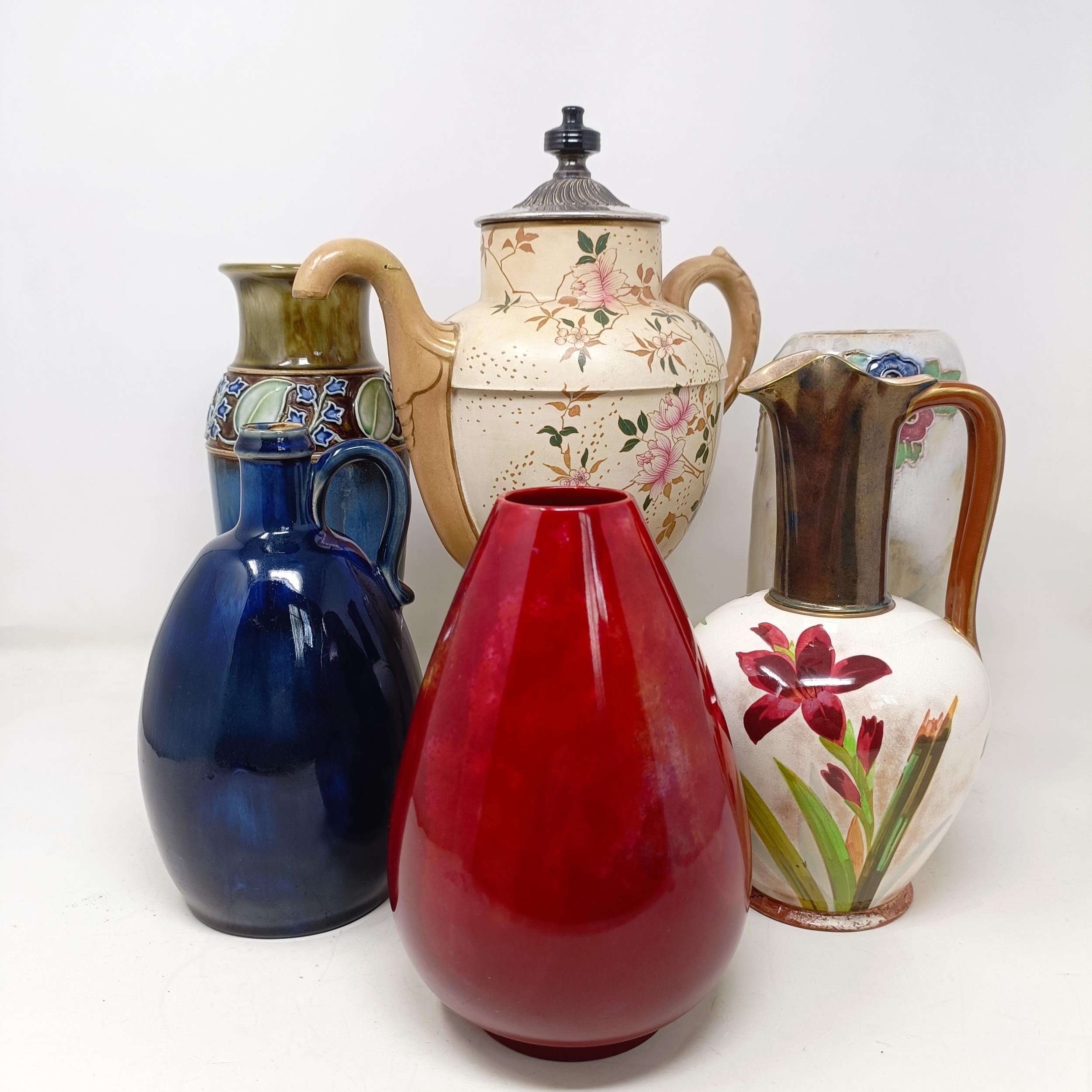 A Royal Doulton Flambé vase, 17 cm high, a Doulton Burslem teapot, two Doulton vases and two jugs (