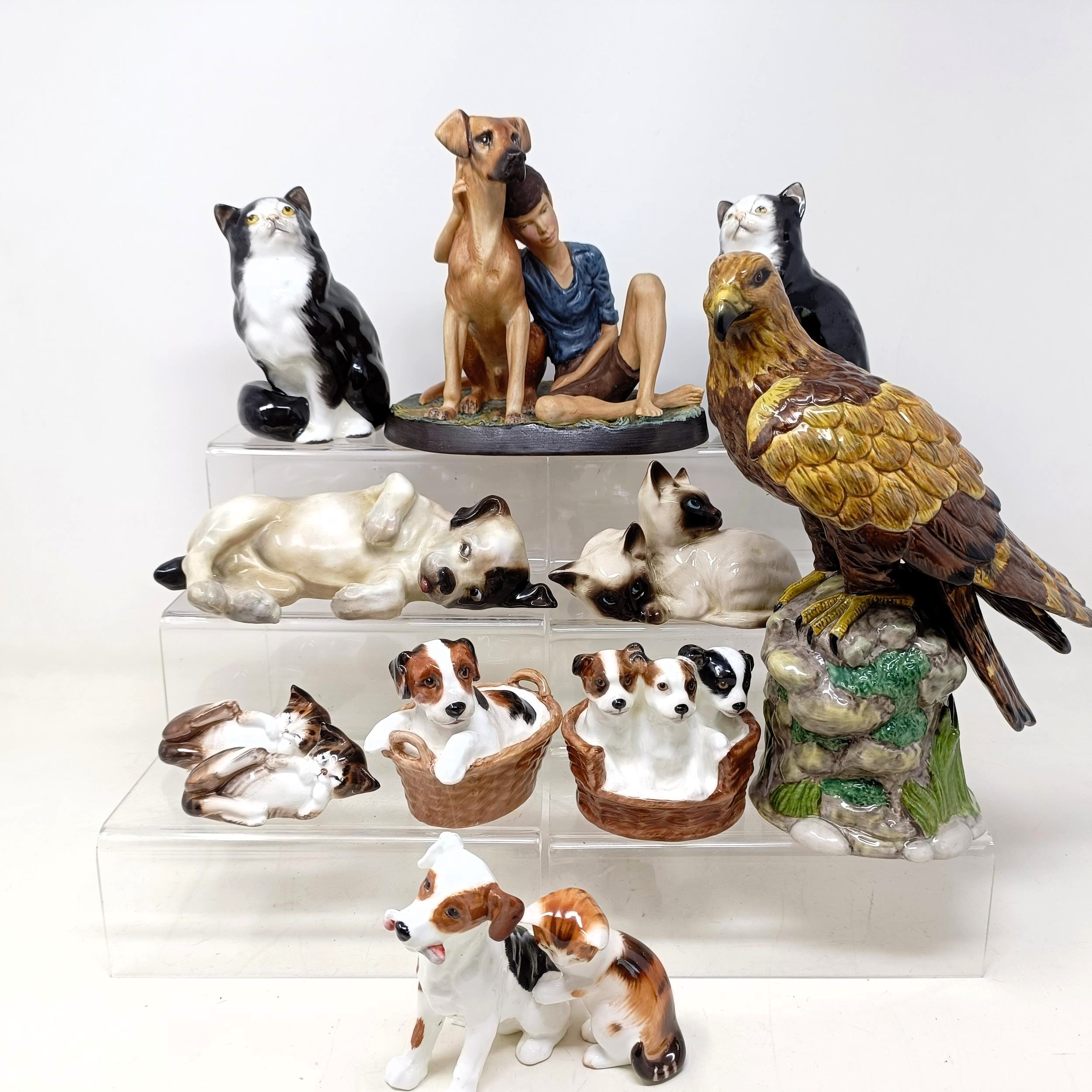 A Royal Doulton figure of a Golden Eagle, RDA36, Buddies HN2546, a figure of a reclining dog, and