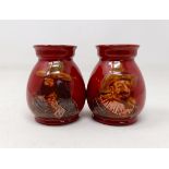 A pair of Royal Doulton squat vases, by Charles Noke, decorated figures, 9 cm high (2)