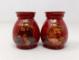 A pair of Royal Doulton squat vases, by Charles Noke, decorated figures, 9 cm high (2)