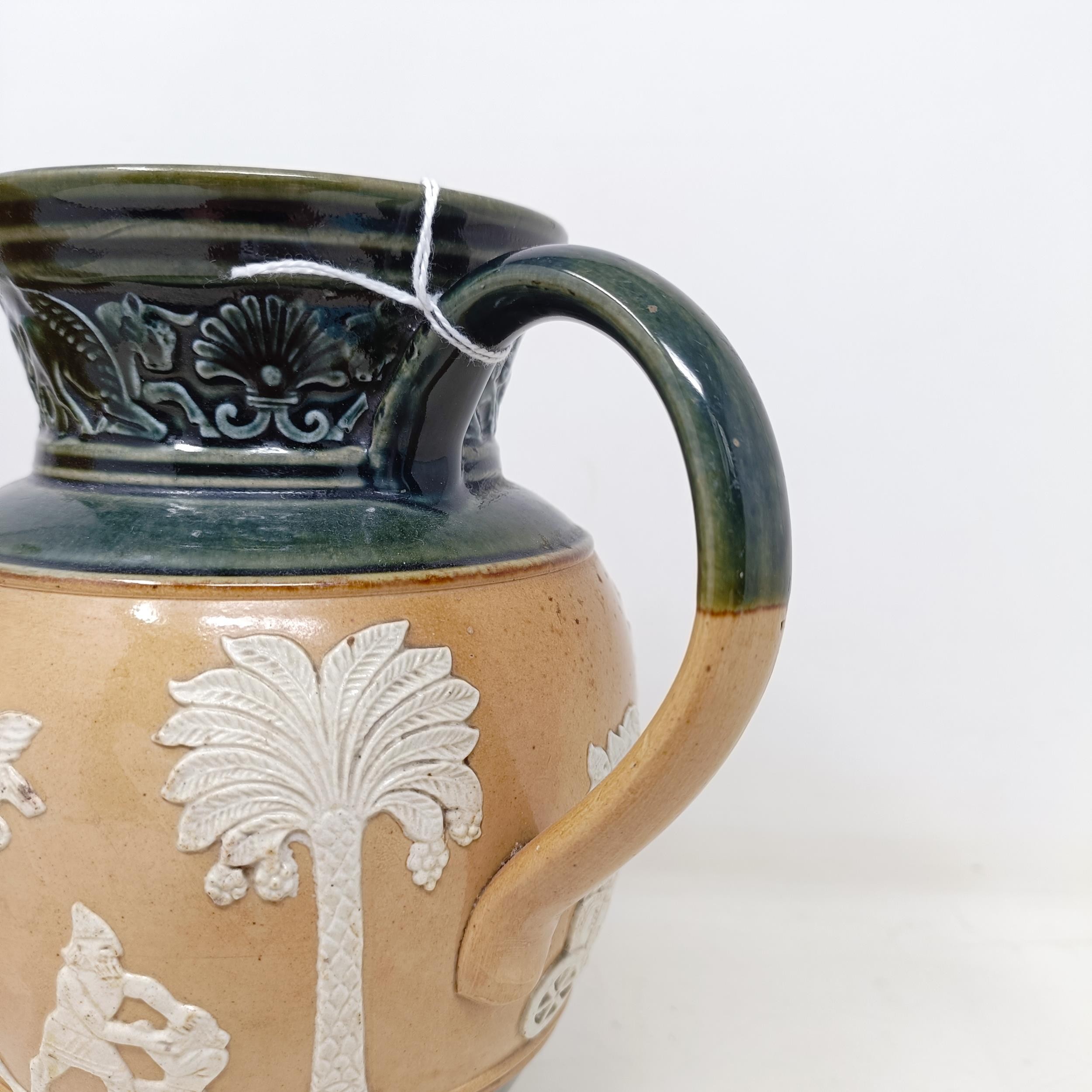 A Doulton Lambeth jug, decorated in Egyptian manner, 20 cm A few rough areas to the touch to the - Image 4 of 8