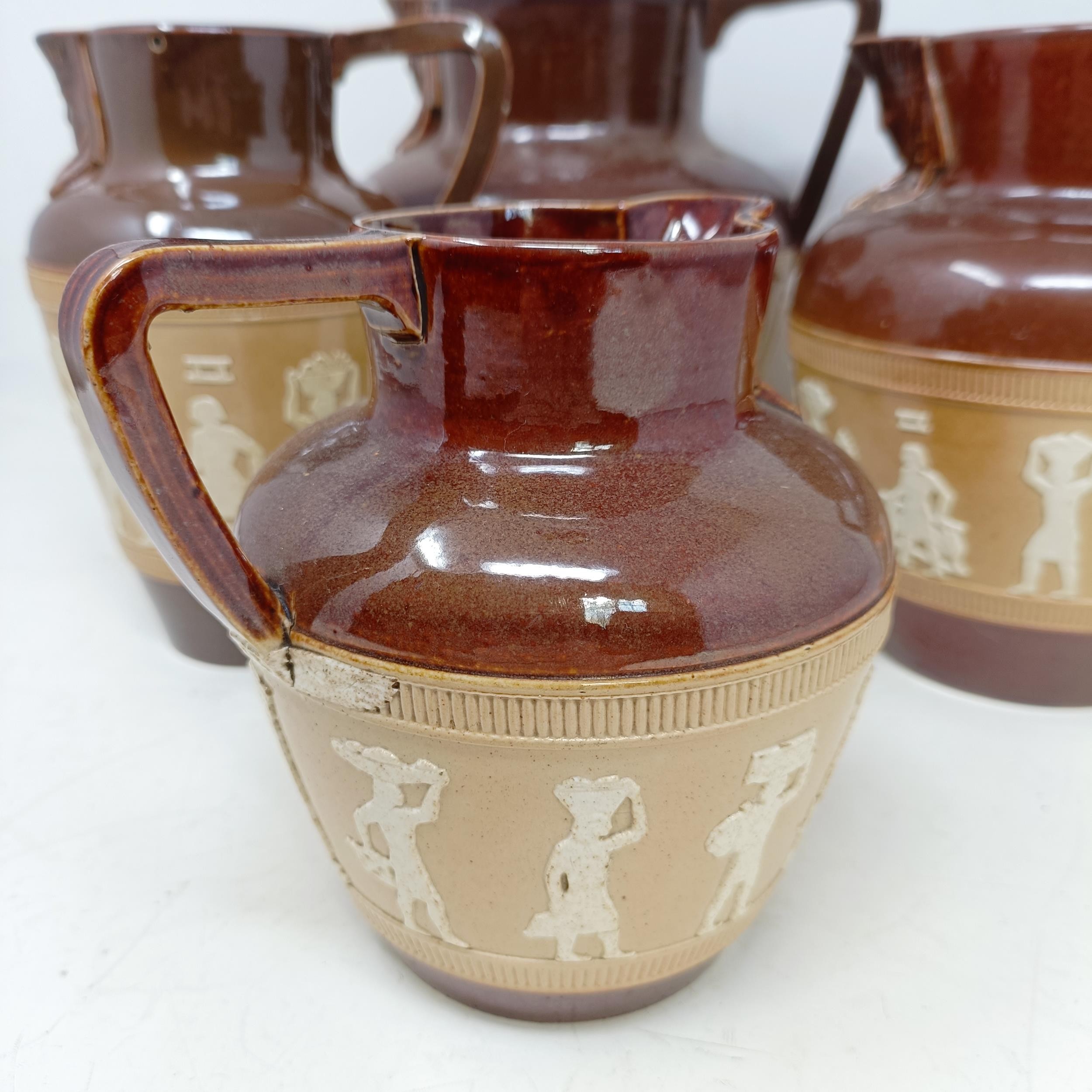 A graduated set of Doulton Lambeth jugs, 20 cm, 18 cm and 14 cm, and another similar, 18 cm (4) - Image 3 of 25