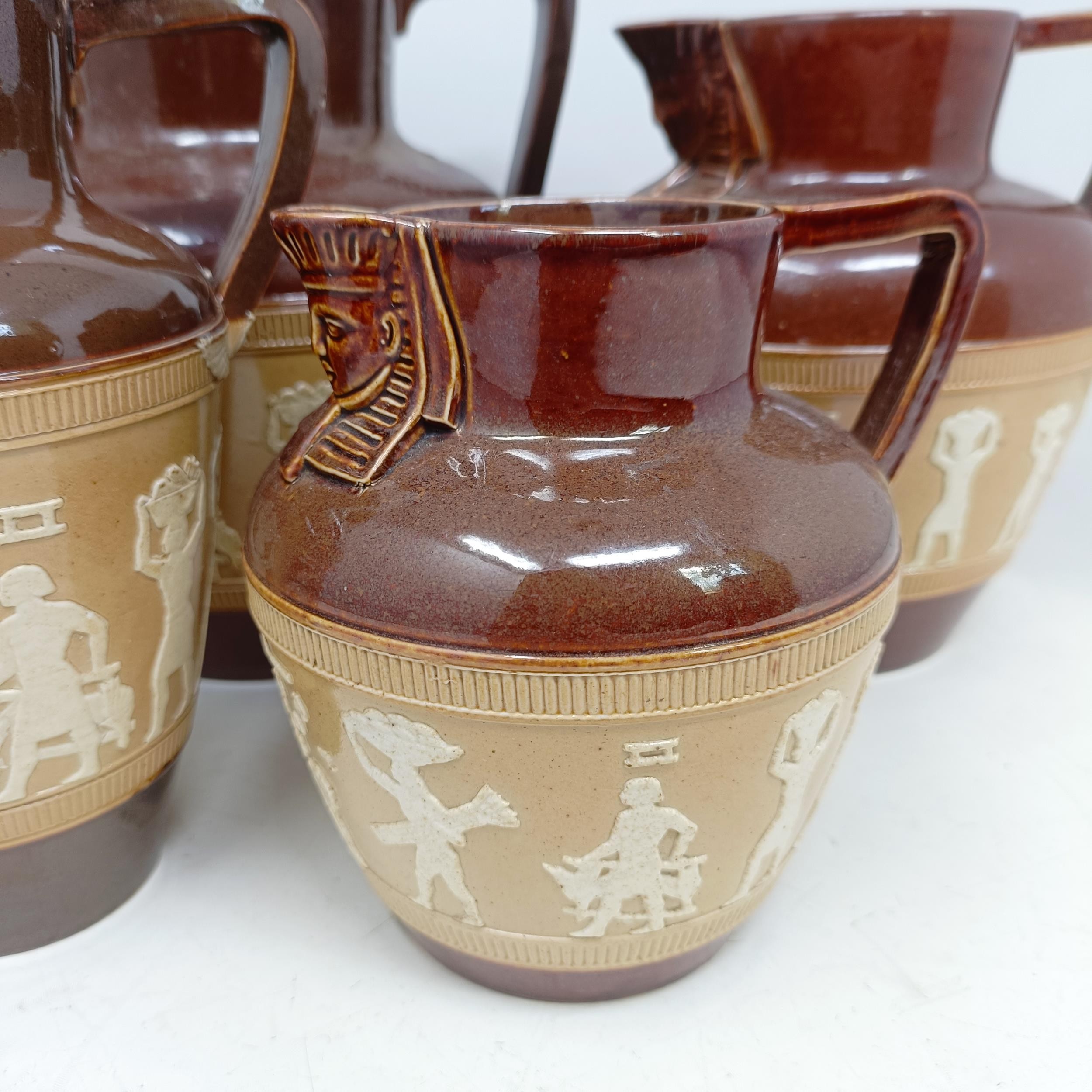 A graduated set of Doulton Lambeth jugs, 20 cm, 18 cm and 14 cm, and another similar, 18 cm (4) - Image 2 of 25