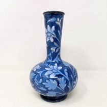 A Doulton Faience vase, by Mina L Crawley, blue ground, decorated flowers, 21 cm high No chips,