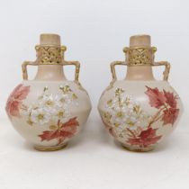 A pair of Doulton Lambeth blush ivory twin handle vases, decorated flowers, highlighted in gilt,