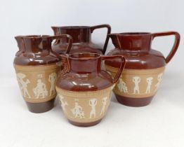 A graduated set of Doulton Lambeth jugs, 20 cm, 18 cm and 14 cm, and another similar, 18 cm (4)