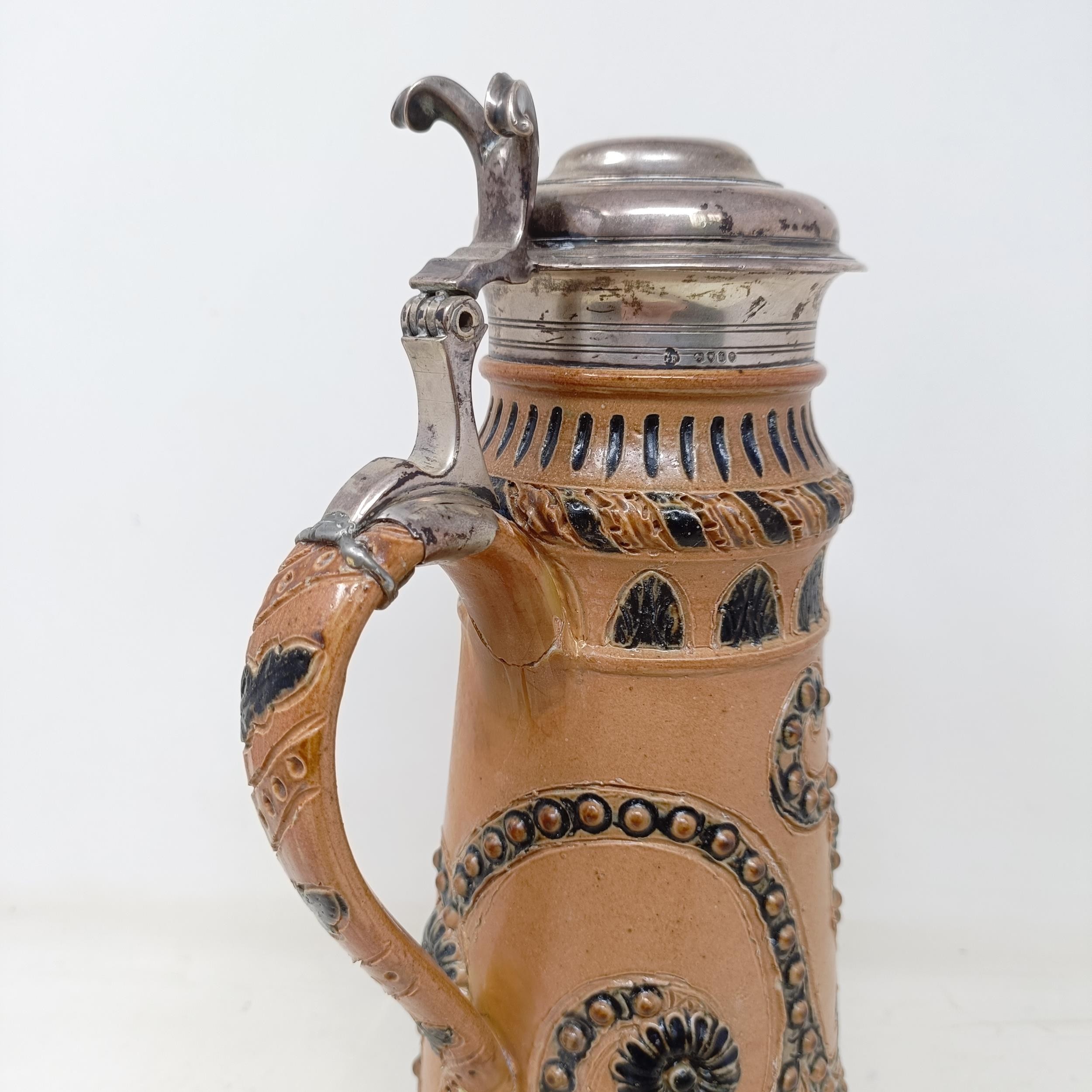 A Doulton Lambeth stoneware flagon, with a silver mount, London 1866, 30 cm high Handle crudely - Image 5 of 10