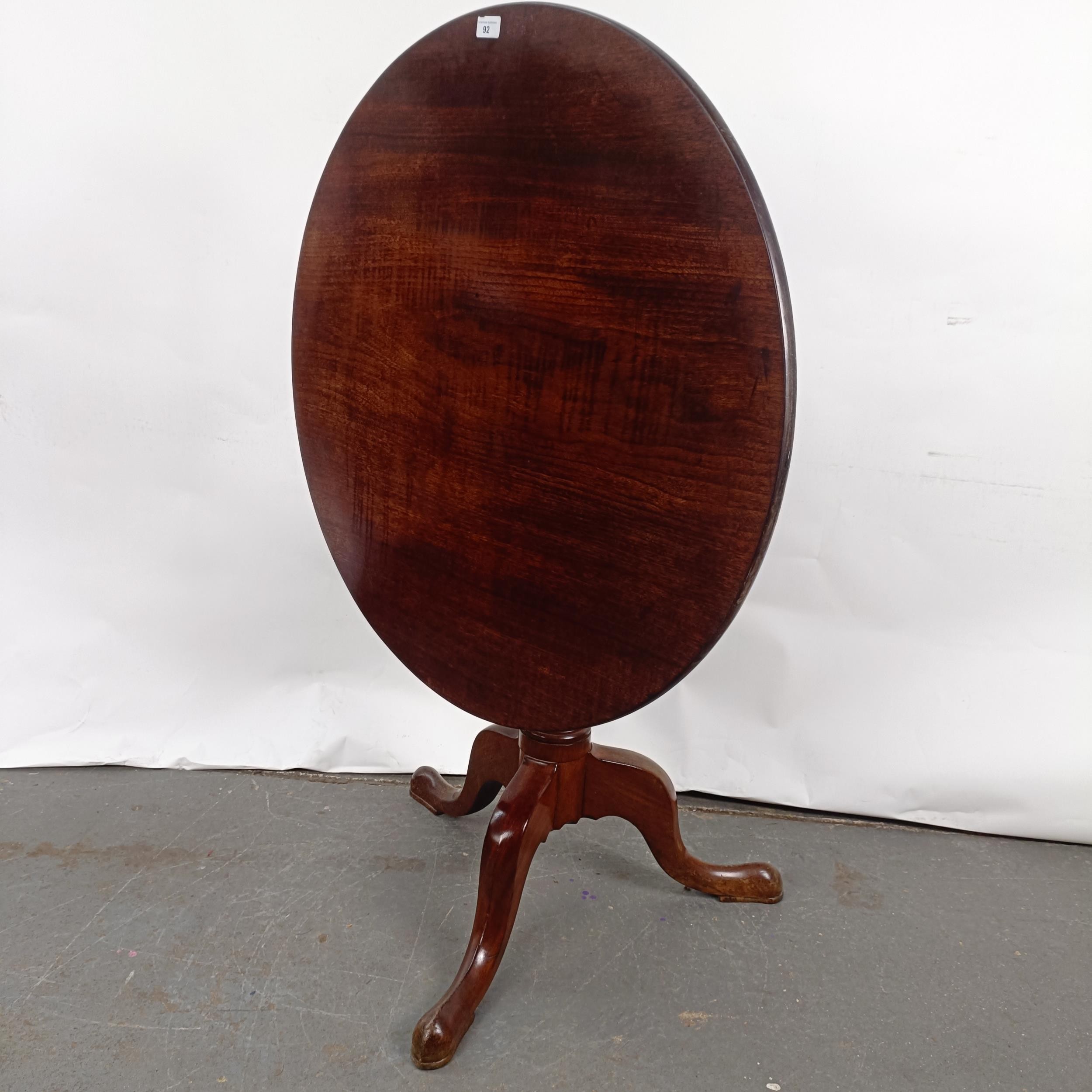 A Victorian mahogany tilt top table, on a column support to a tripod base, 86 cm diameter Slight - Image 2 of 7