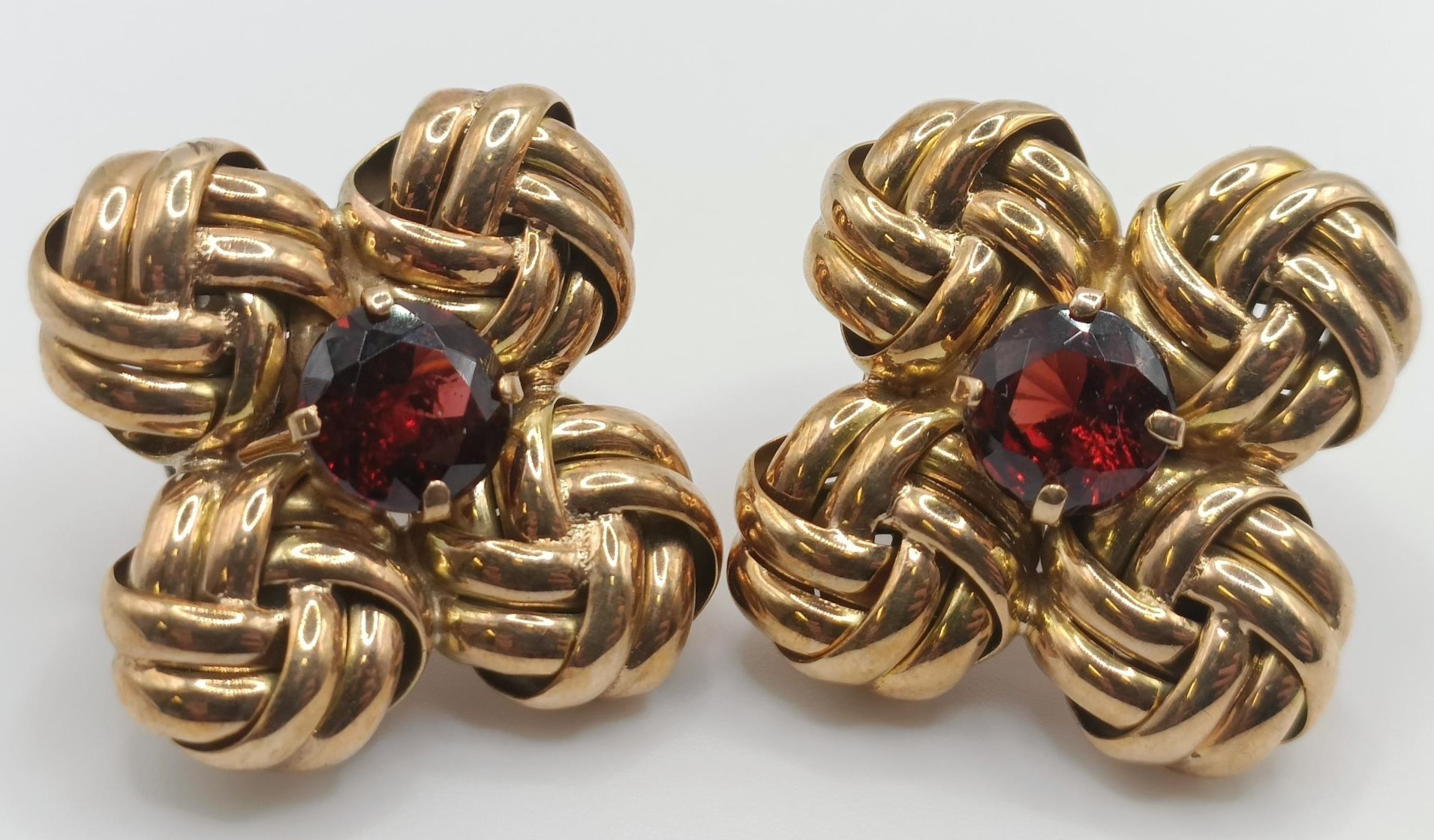 A pair of yellow metal and garnet clip on earrings