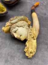 A Victorian clay pipe in the shape of a lady