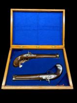 A replica vintage pair of percussion pistols, boxed