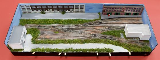 N GAUGE TRACK LAYOUT. Small contained straight layout with warehouse and garage. Approximately 68 x
