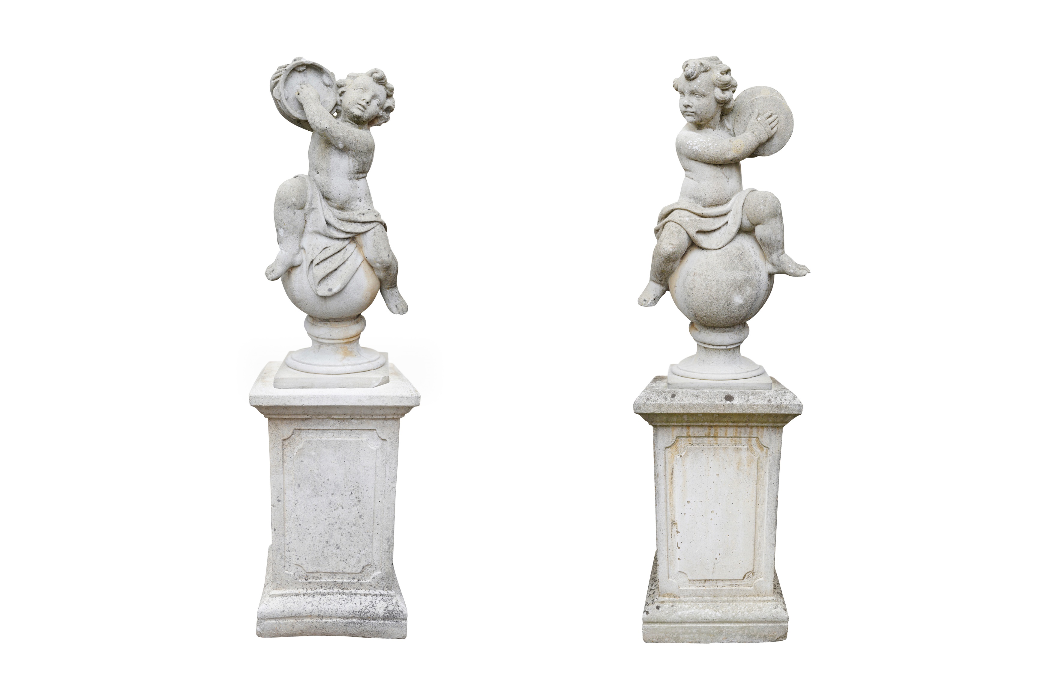 A PAIR OF COMPOSITION STONE MUSICAL PUTTI