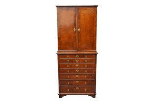 A FEATHER BANDED WALNUT CABINET ON CHEST CIRCA 1920-1930