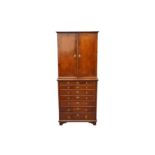 A FEATHER BANDED WALNUT CABINET ON CHEST CIRCA 1920-1930