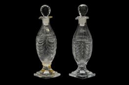 A PAIR OF REGENCY CUT GLASS VINEGAR BOTTLES, CIRCA 1800