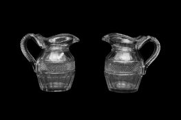 A PAIR OF REGENCY GLASS WATER JUGS OF HELMET SHAPE, CIRCA 1800