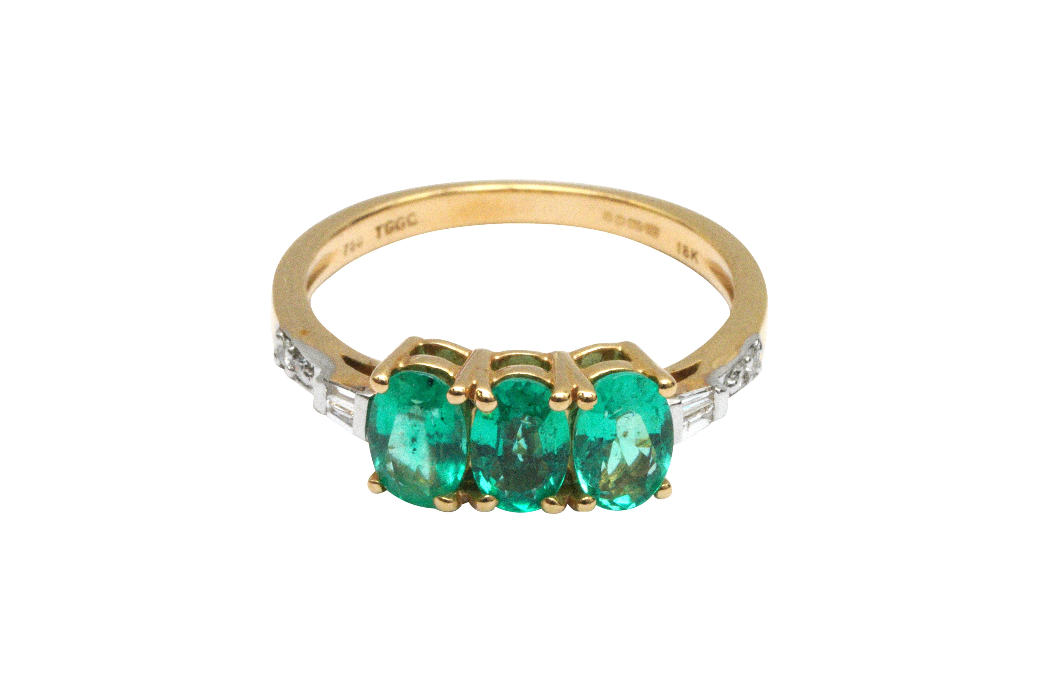 A THREE-STONE EMERALD RING