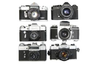 Six Mechanical 35mm SLR Cameras With Lenses.