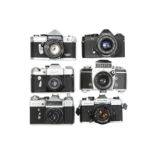 Six Mechanical 35mm SLR Cameras With Lenses.