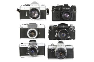 Six Mechanical 35mm SLR Cameras With Lenses.