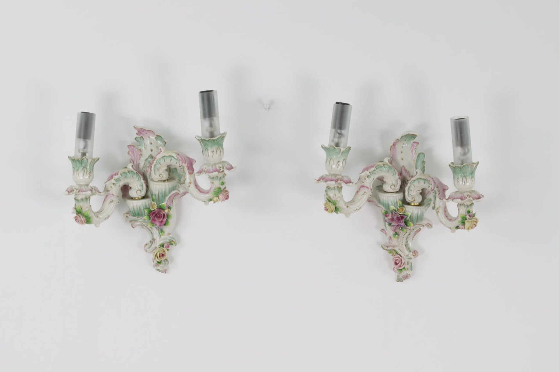 A pair of rococo porcelain hand-painted wall sconces, 20th Century