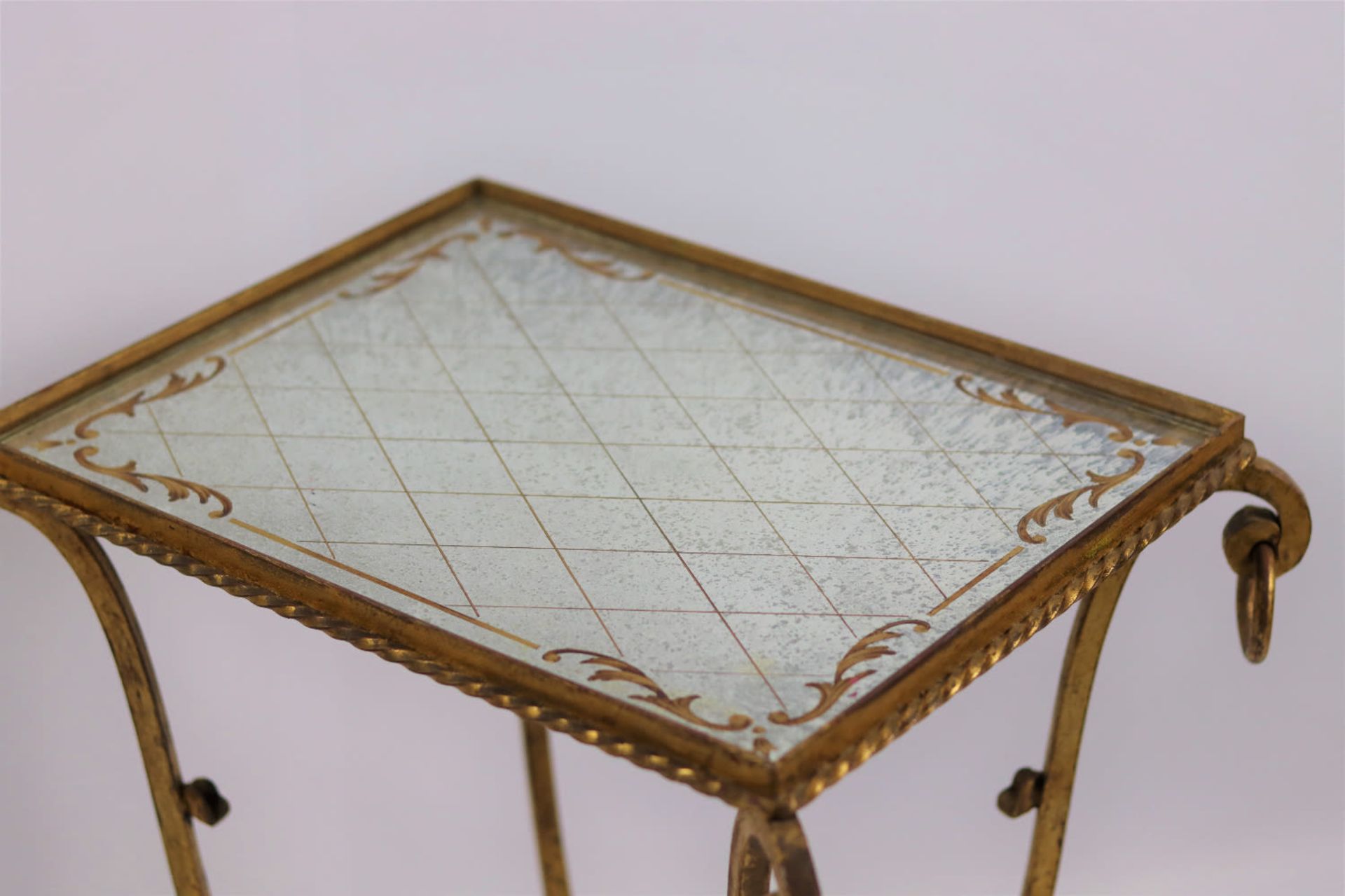 A wrought iron end side table with a gold glomyized mirrored glass top. Mid 20th Century - Image 2 of 2